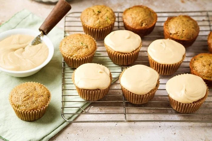 Freshly baked zucchini cupcakes topped with cream cheese frosting