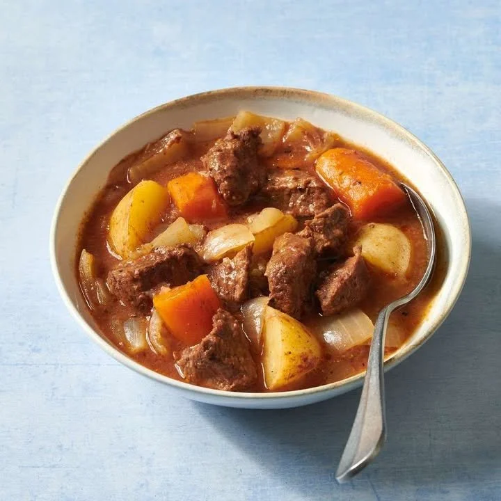 Delicious bowl of hearty beef stew with vegetables and herbs