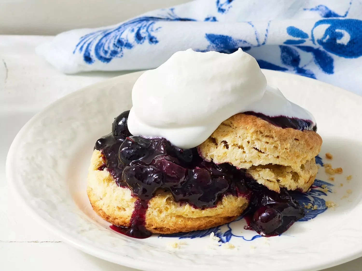 Delicious homemade Blueberry Shortcake topped with fresh blueberries and whipped cream.