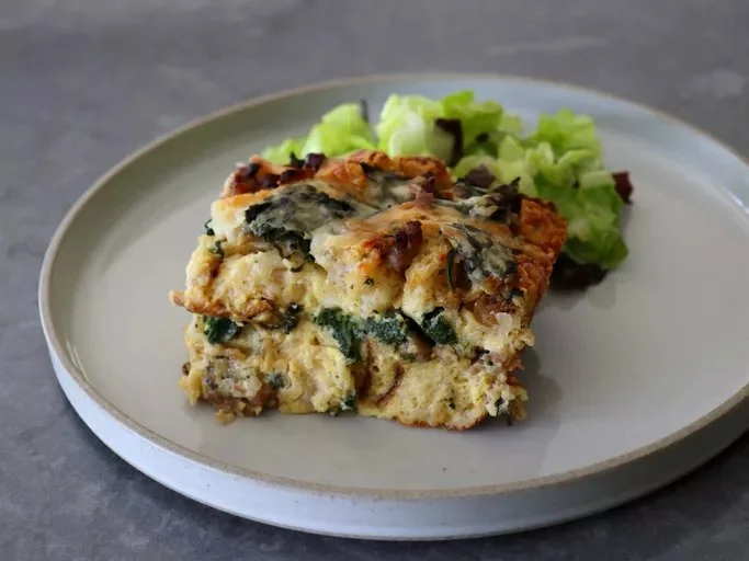 Delicious breakfast strata with eggs, cheese, and vegetables baked to perfection.