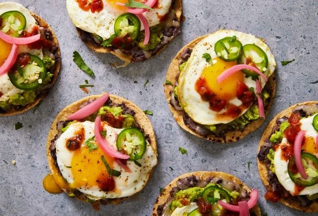 Delicious Breakfast Tostadas topped with eggs, veggies, and salsa.