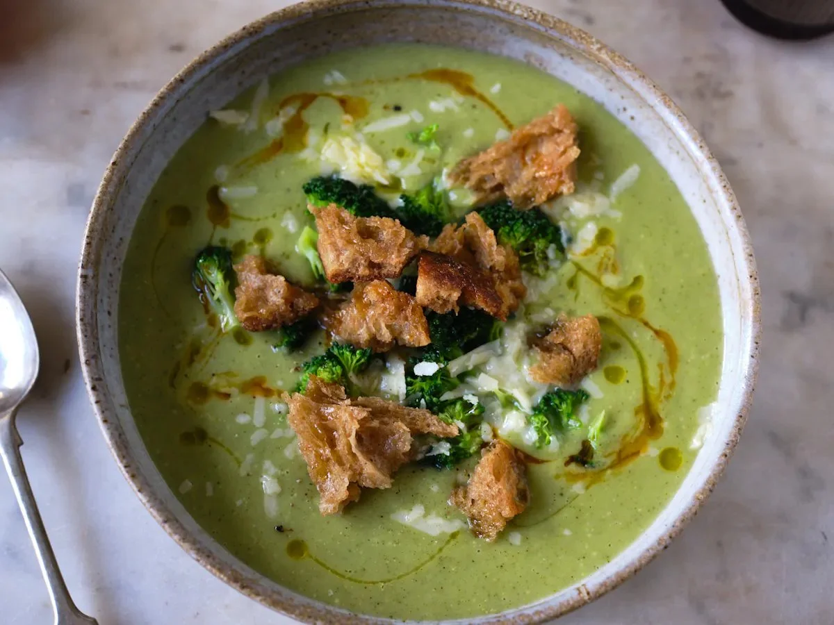 Bowl of broccoli cheddar soup garnished with croutons