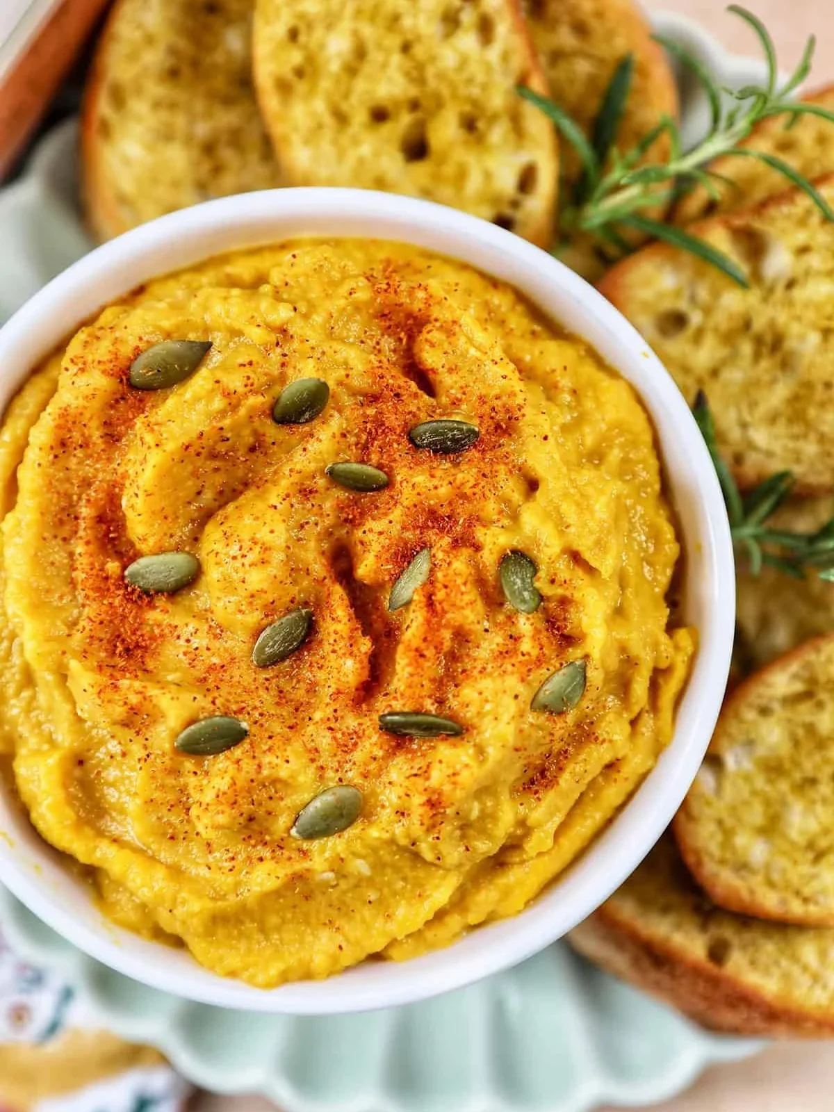 Creamy butternut squash and roasted garlic dip served in a bowl