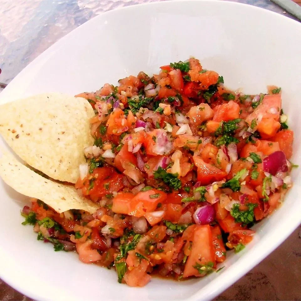 A bowl of fresh California Salsa with colorful diced tomatoes and cilantro.