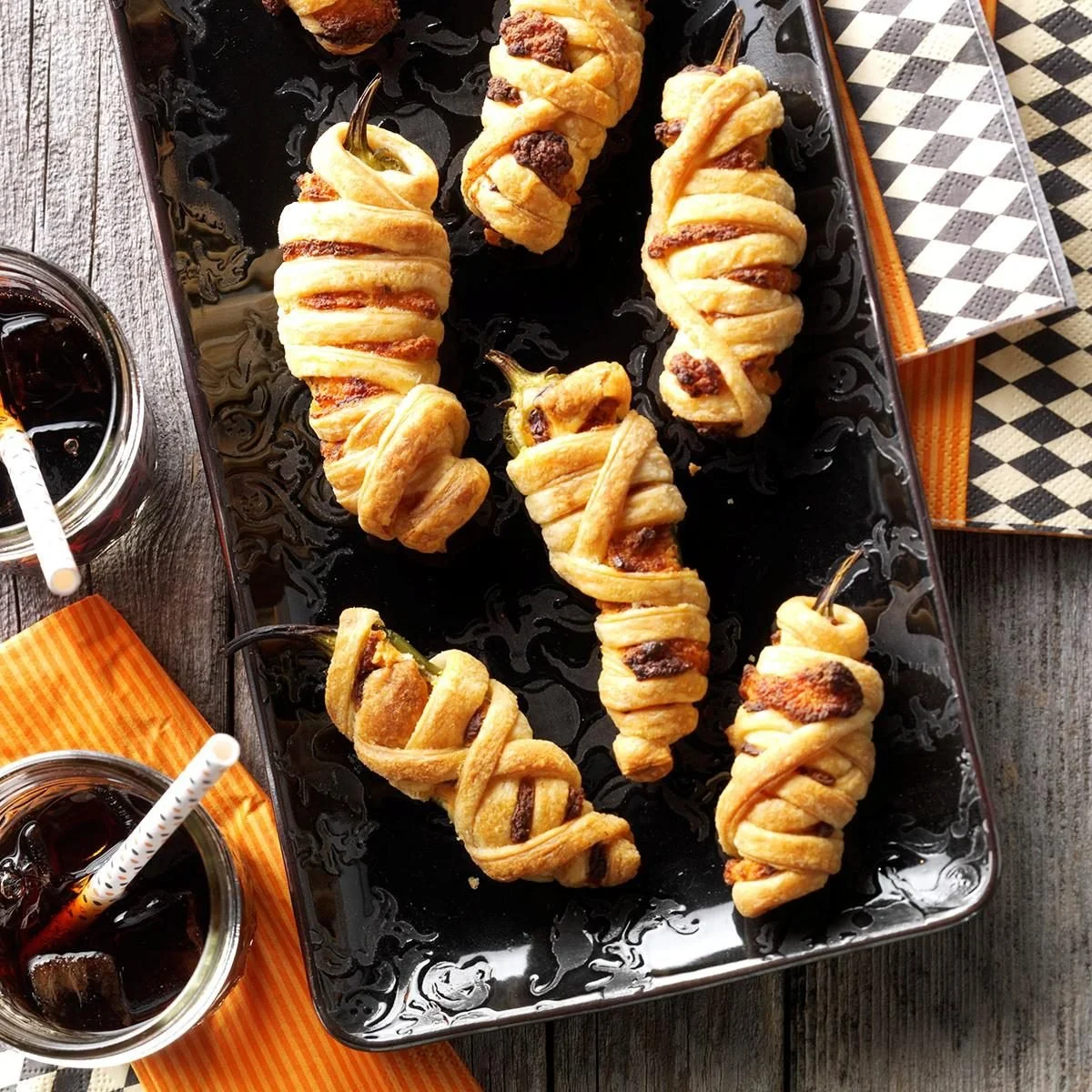 Cheesy jalapeno poppers wrapped in puff pastry on a serving platter