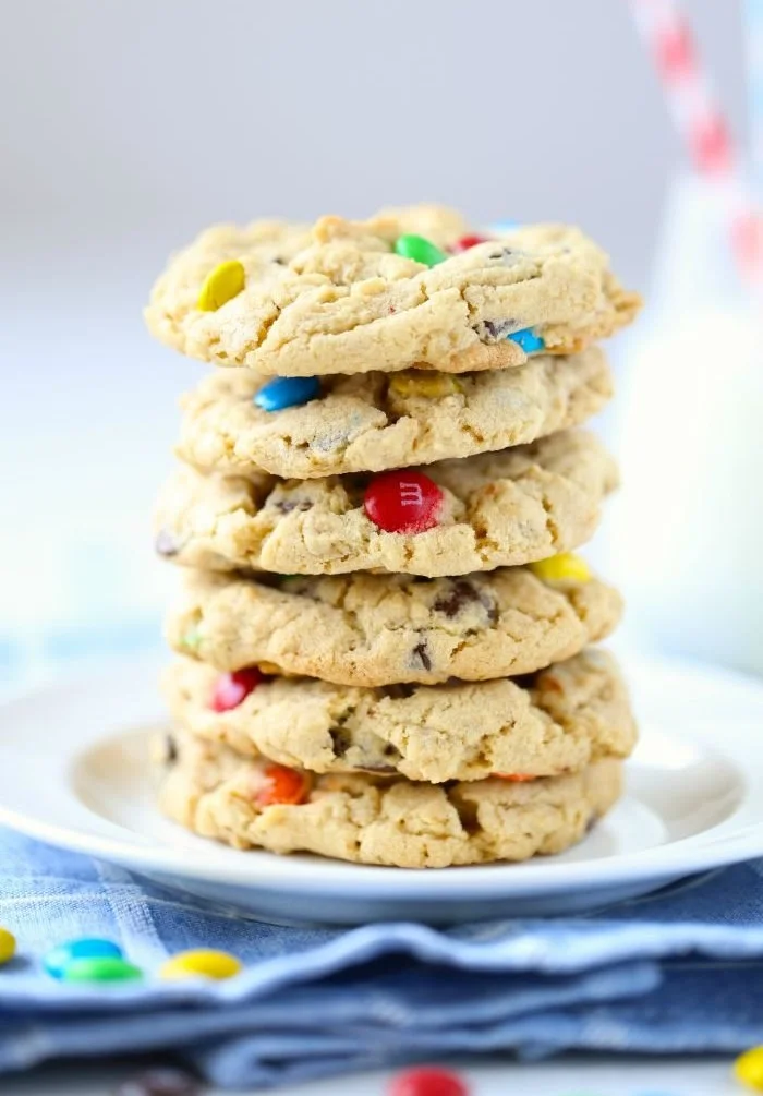 Chewy M&M cookies fresh out of the oven on a cooling rack