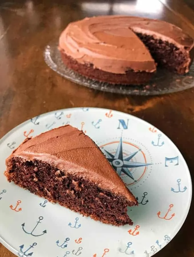 Delicious Chocolate Banana Cake topped with chocolate frosting and banana slices.