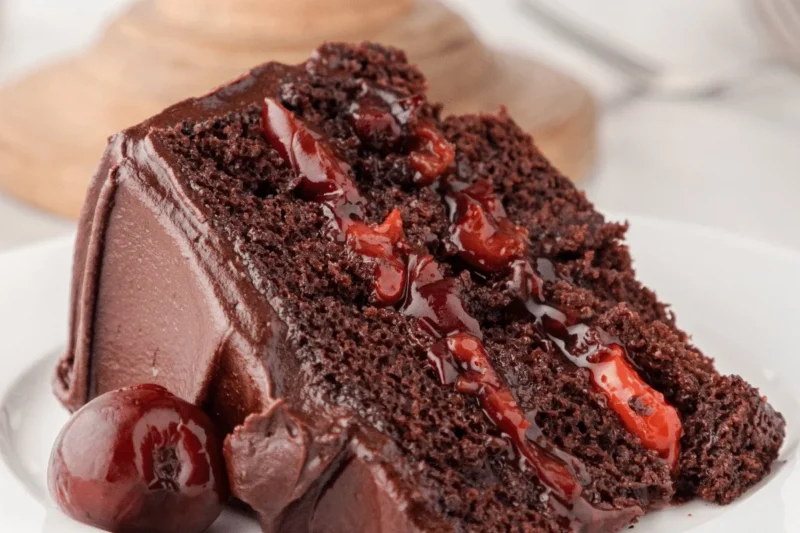 Delicious Chocolate Cherry Cake topped with cherries and chocolate frosting