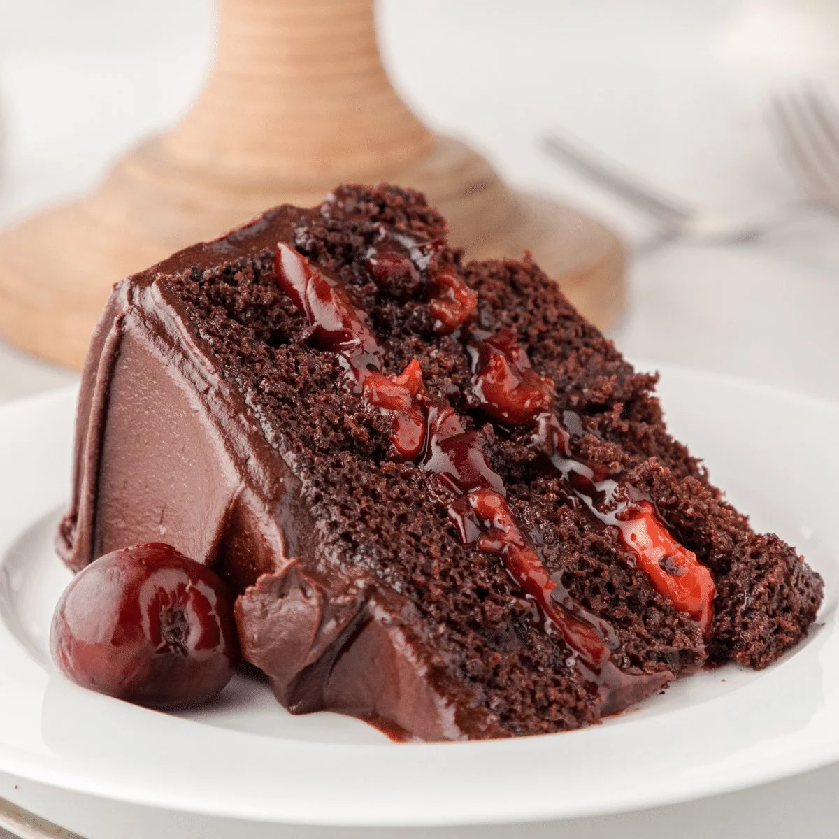 Delicious Chocolate Cherry Cake topped with cherries and chocolate frosting