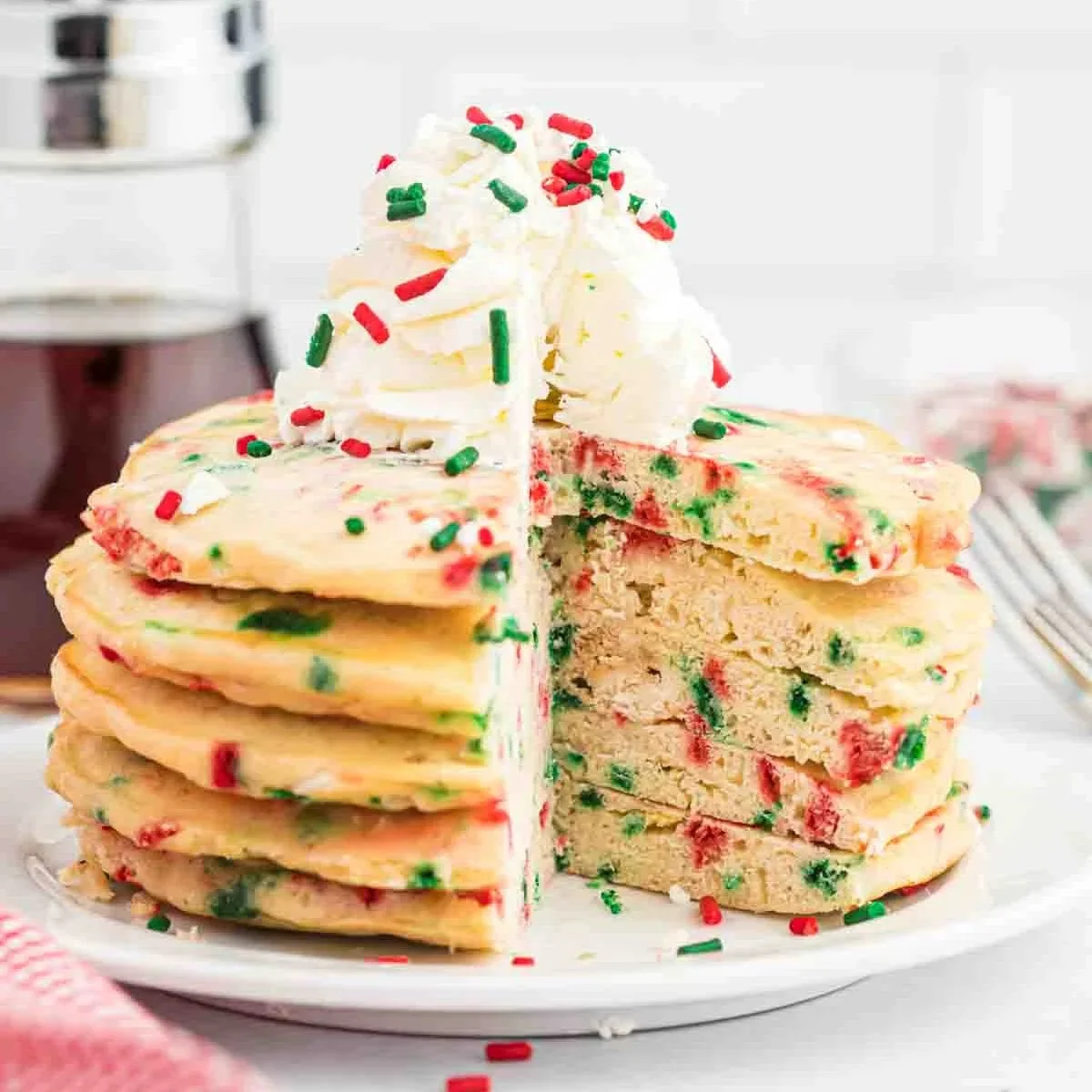 Stack of delicious Christmas Pancakes topped with festive decorations