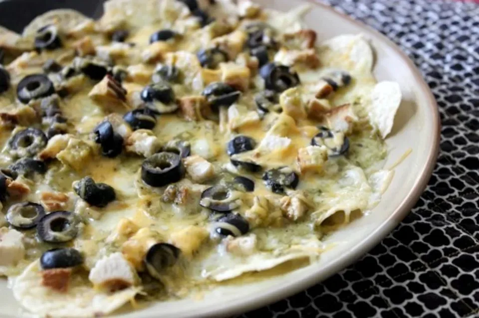 Delicious Chunky Chicken Nachos topped with cheese and toppings