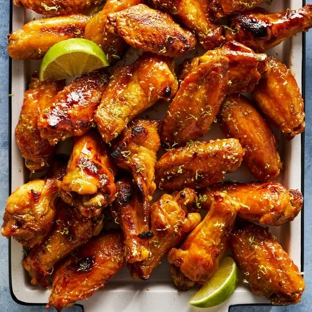 Delicious Coconut-Lime Chicken Wings garnished with lime slices