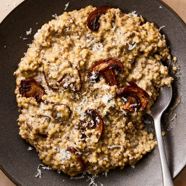 Cream of Mushroom Pastina served in a bowl with herbs and spices.