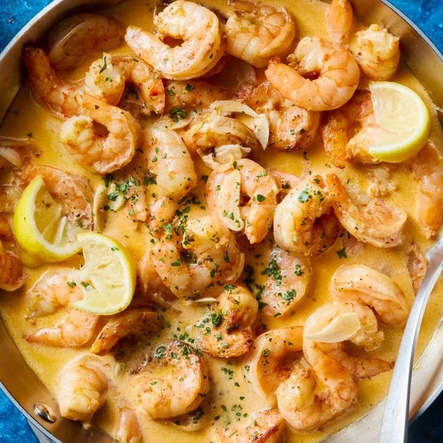 Creamy lemon garlic shrimp dish served with herbs