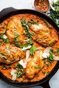 Creamy tomato chicken skillet dinner served with vegetables