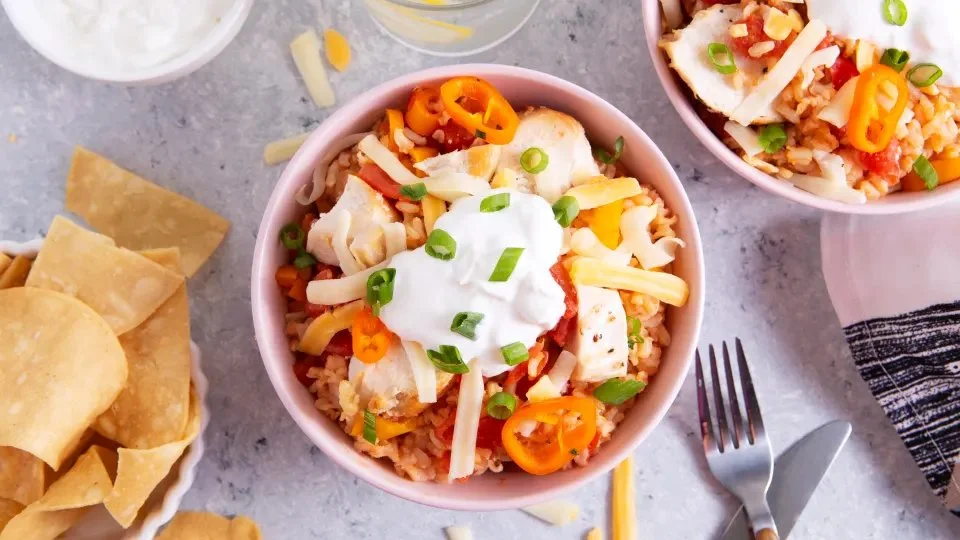 Crock Pot Fiesta Chicken served with colorful toppings and garnishes