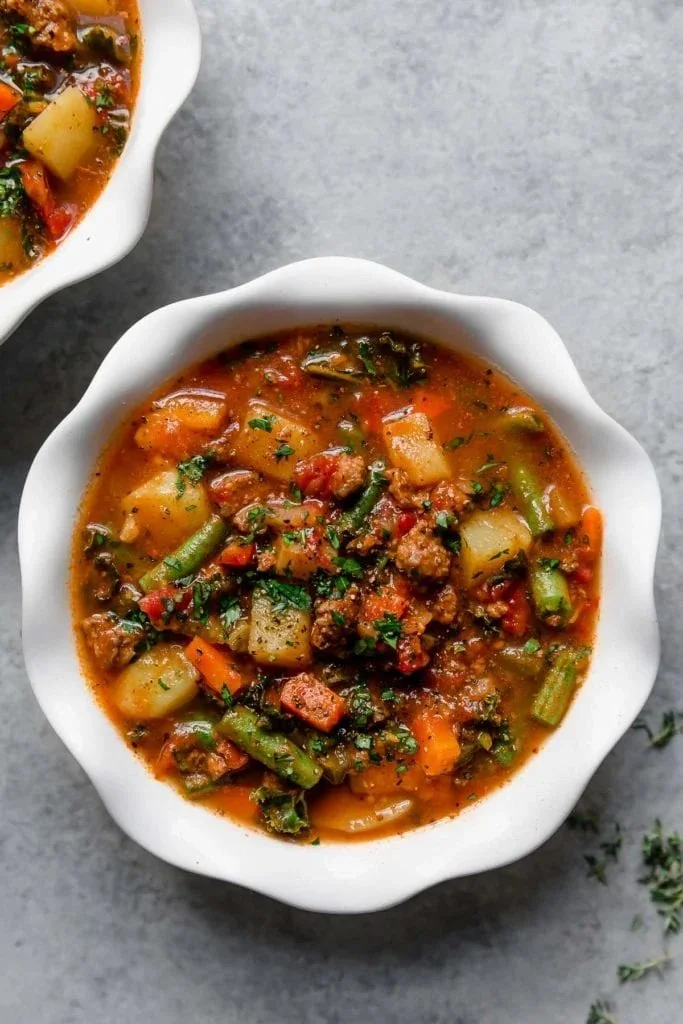 Healthy Crock Pot Hamburger Soup in a bowl with fresh vegetables