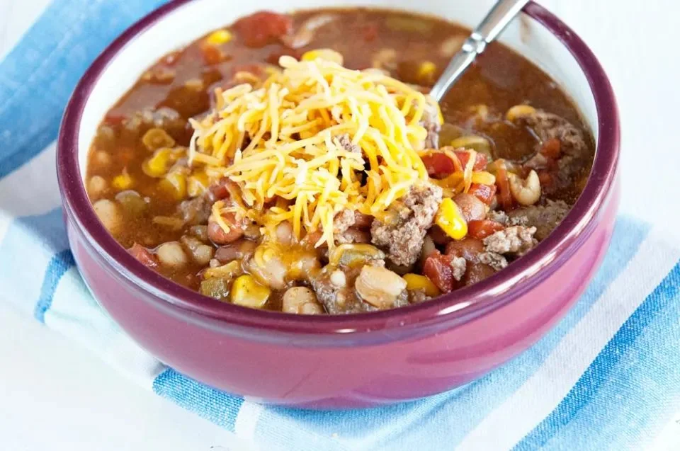 Bowl of delicious Crock Pot Taco Soup topped with cheese and cilantro
