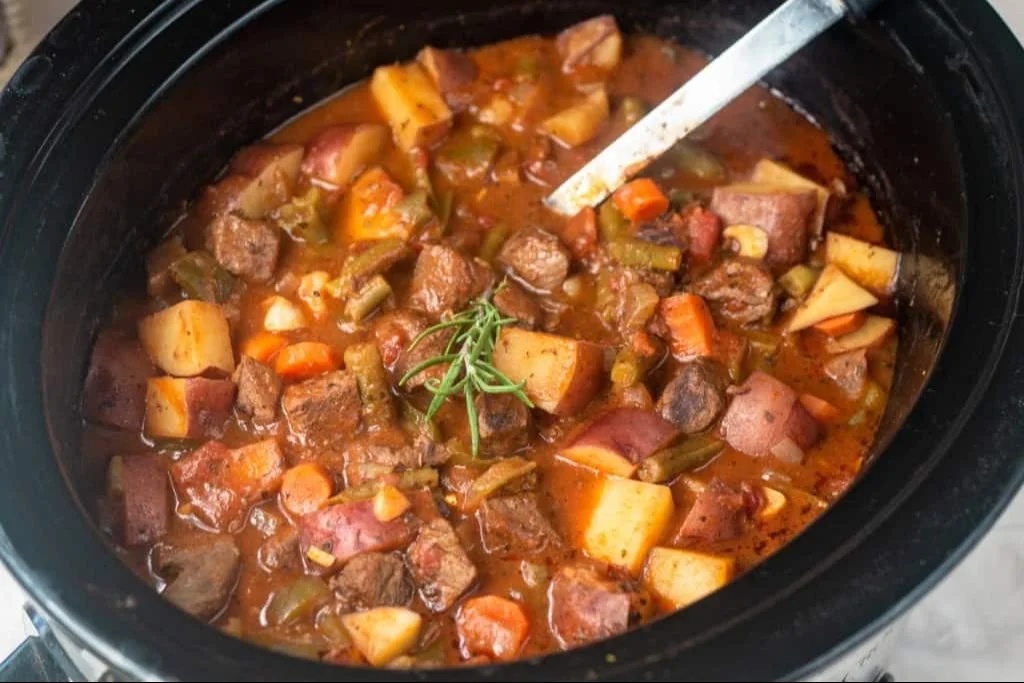 Delicious crockpot elk stew simmering in a bowl with vegetables.