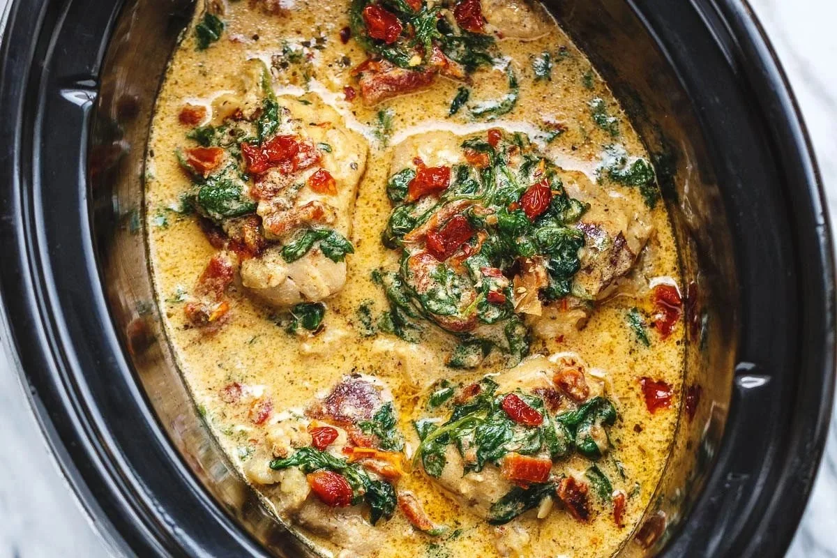 Crockpot Tuscan Chicken Thighs served with fresh herbs and vegetables