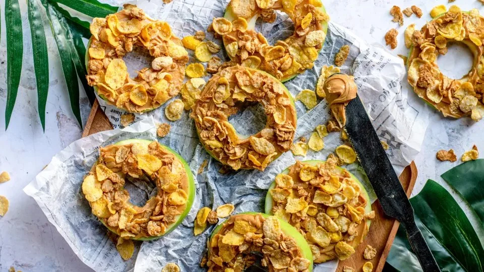 Crunchy apple rings on a wooden plate, ready to be enjoyed as a healthy snack.