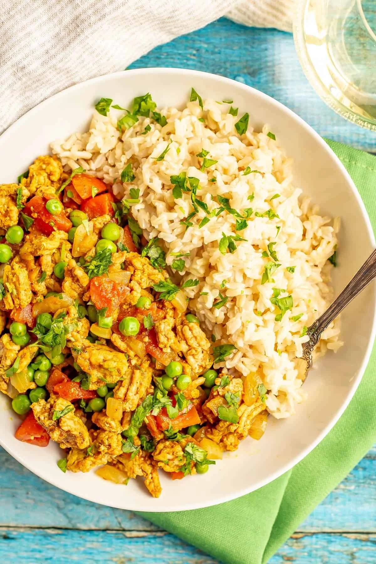 Curry ground turkey served with rice and peas in a vibrant dish