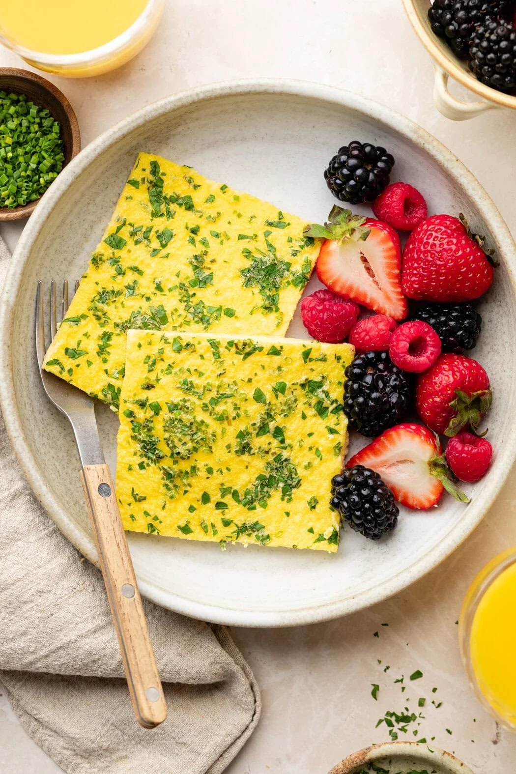 Fluffy sheet pan eggs with cottage cheese served in a vibrant dish