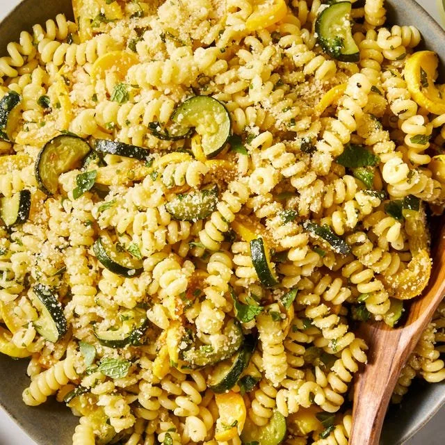 Garlic Parmesan Summer Squash Pasta in a bowl garnished with herbs