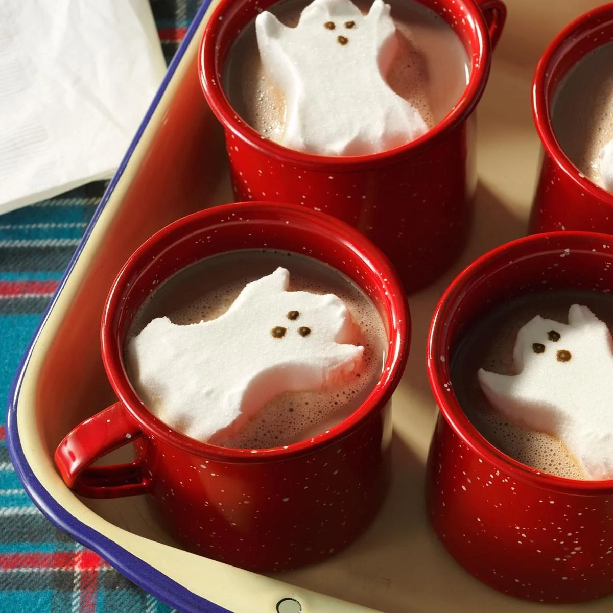 A steaming mug of ghostly hot cocoa with spooky marshmallows, perfect for Halloween.