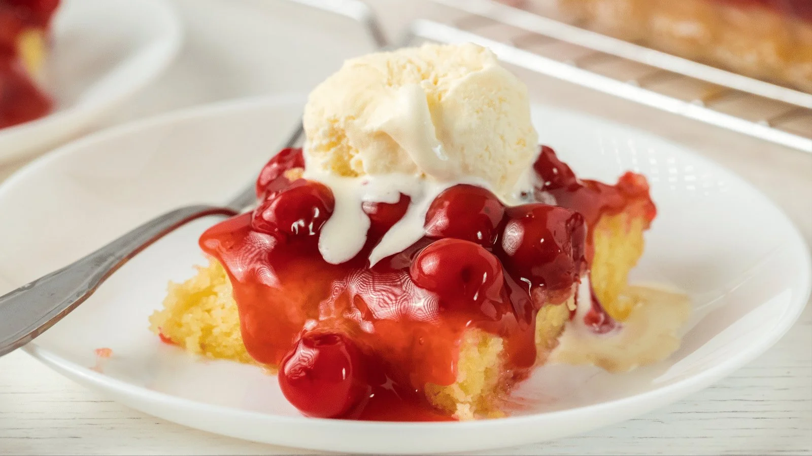 Gluten-free cherry almond cake topped with fresh cherries and almonds