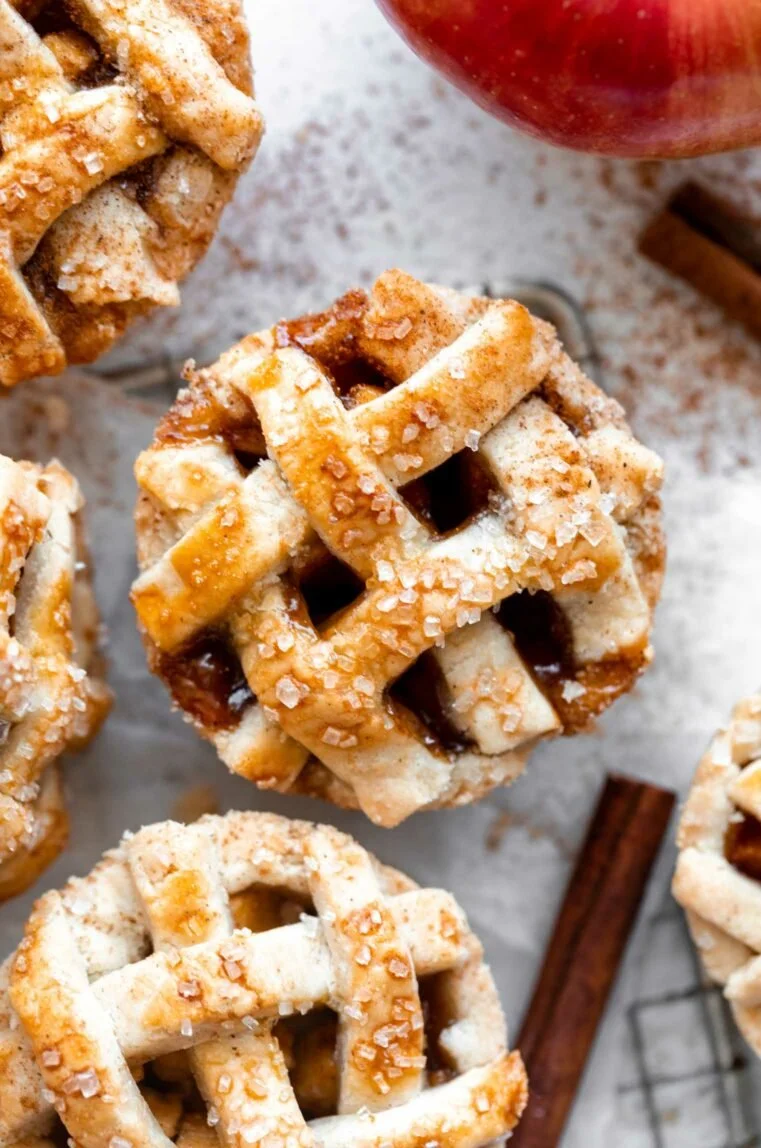 Gluten-free mini apple pies baked in a muffin tray for a perfect dessert.