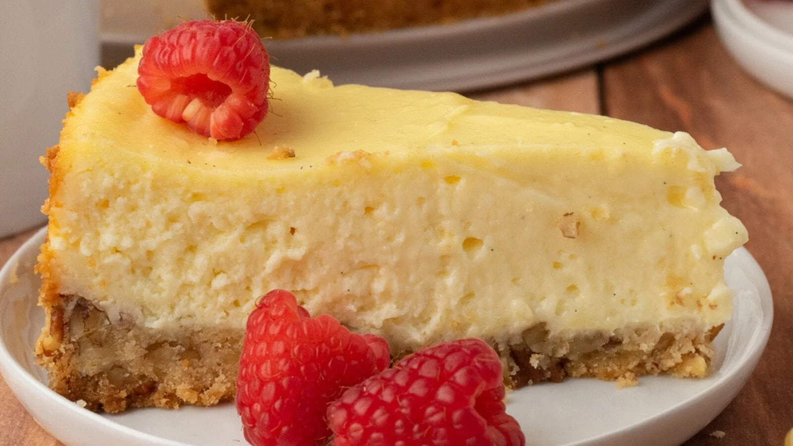 Gluten-free pecan crust cheesecake topped with caramel drizzle and pecans