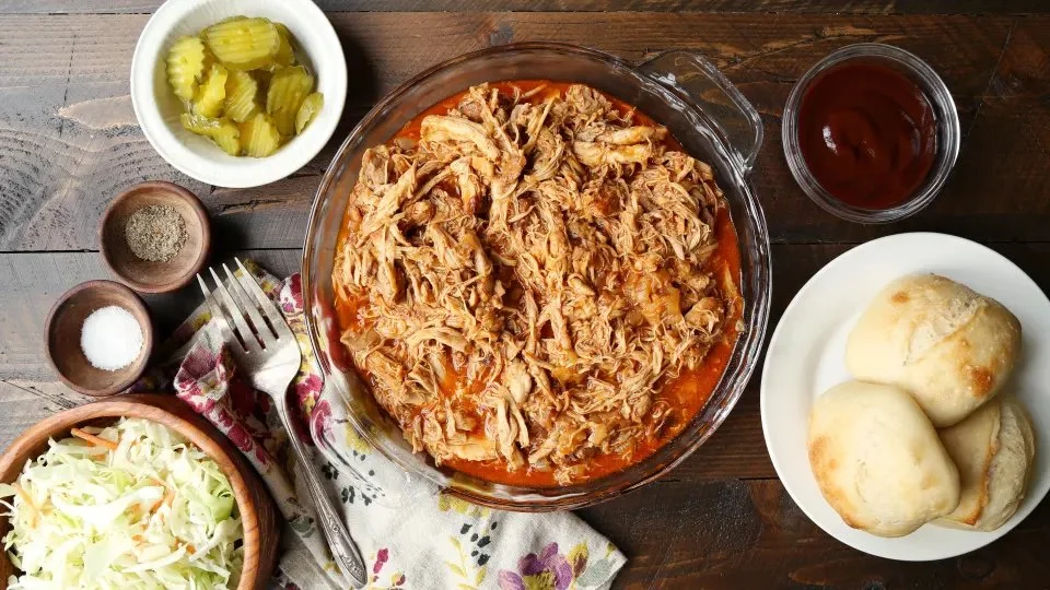 Instant Pot Bourbon BBQ Chicken served with a side of coleslaw and cornbread
