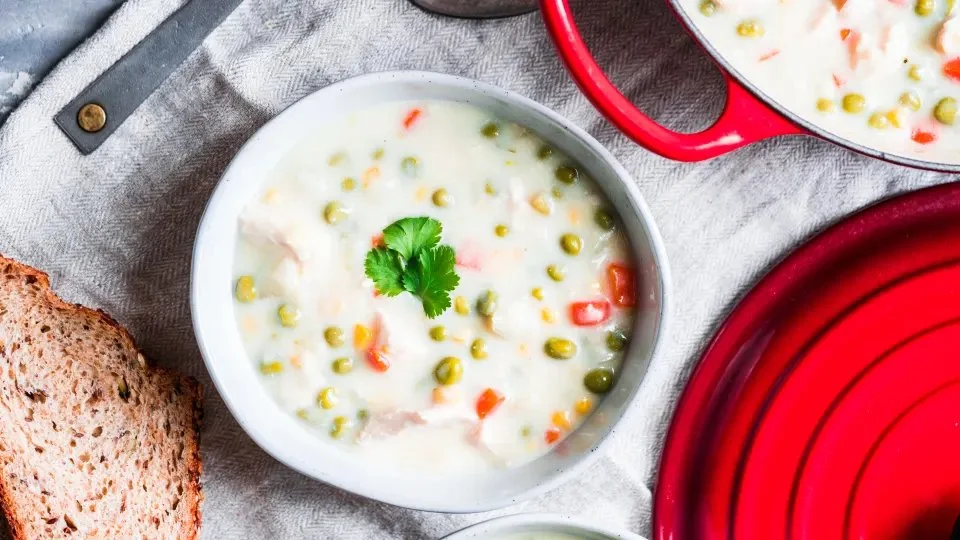 Bowl of creamy Instant Pot Chicken Chowder topped with herbs