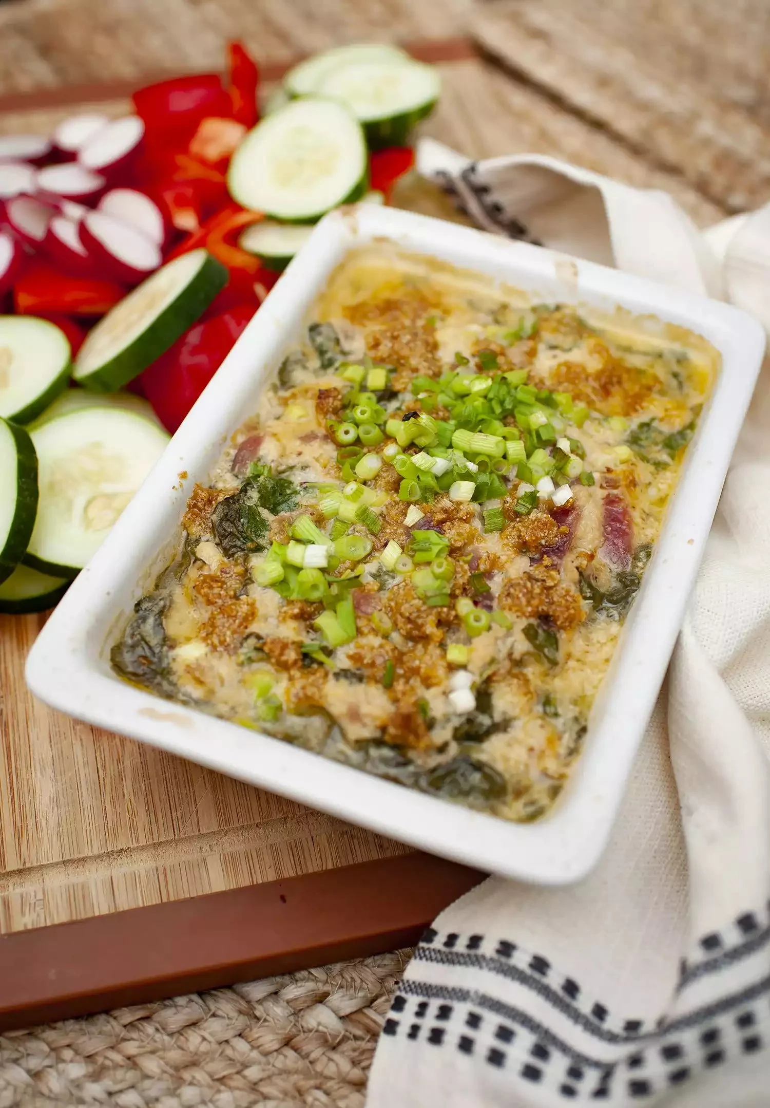 Delicious Instant Pot Spinach Crab Dip served in a bowl with crackers and garnishes