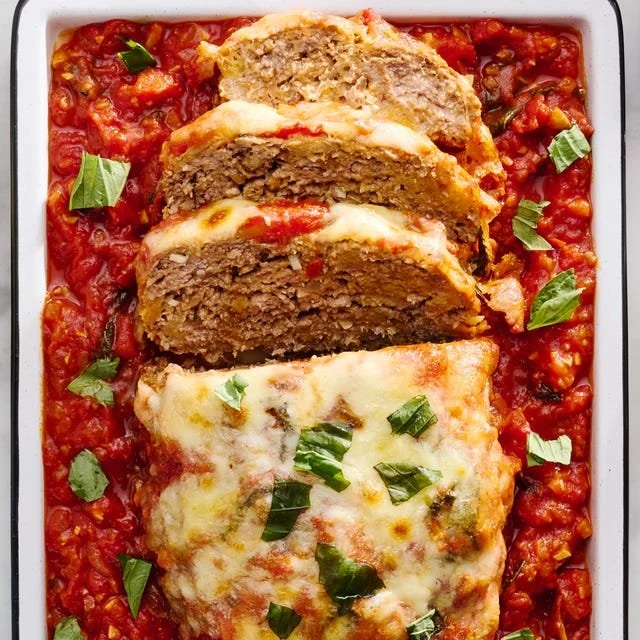 Deliciously cooked Italian Meatloaf garnished with herbs and served on a plate.