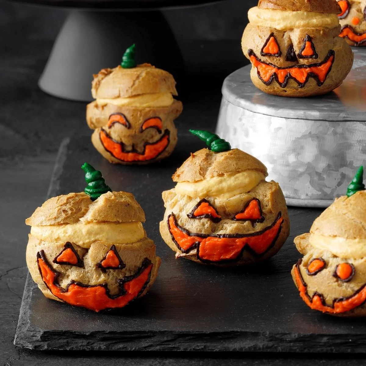 Jack o' Lantern cream puffs with pumpkin filling and festive decorations