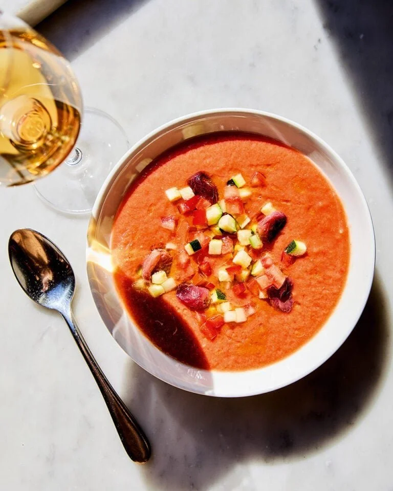 Bowl of José Pizarro's gazpacho with roasted grapes garnished beautifully.