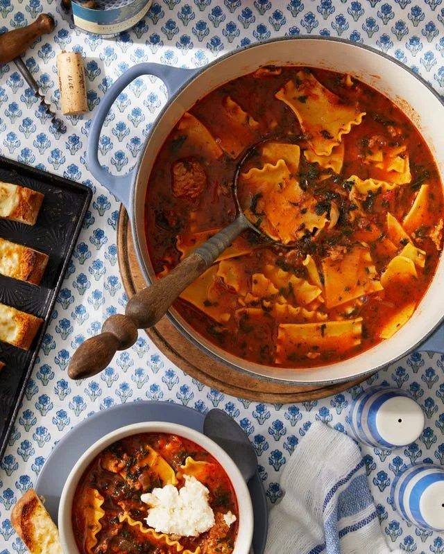 Delicious bowl of lasagna soup garnished with herbs.
