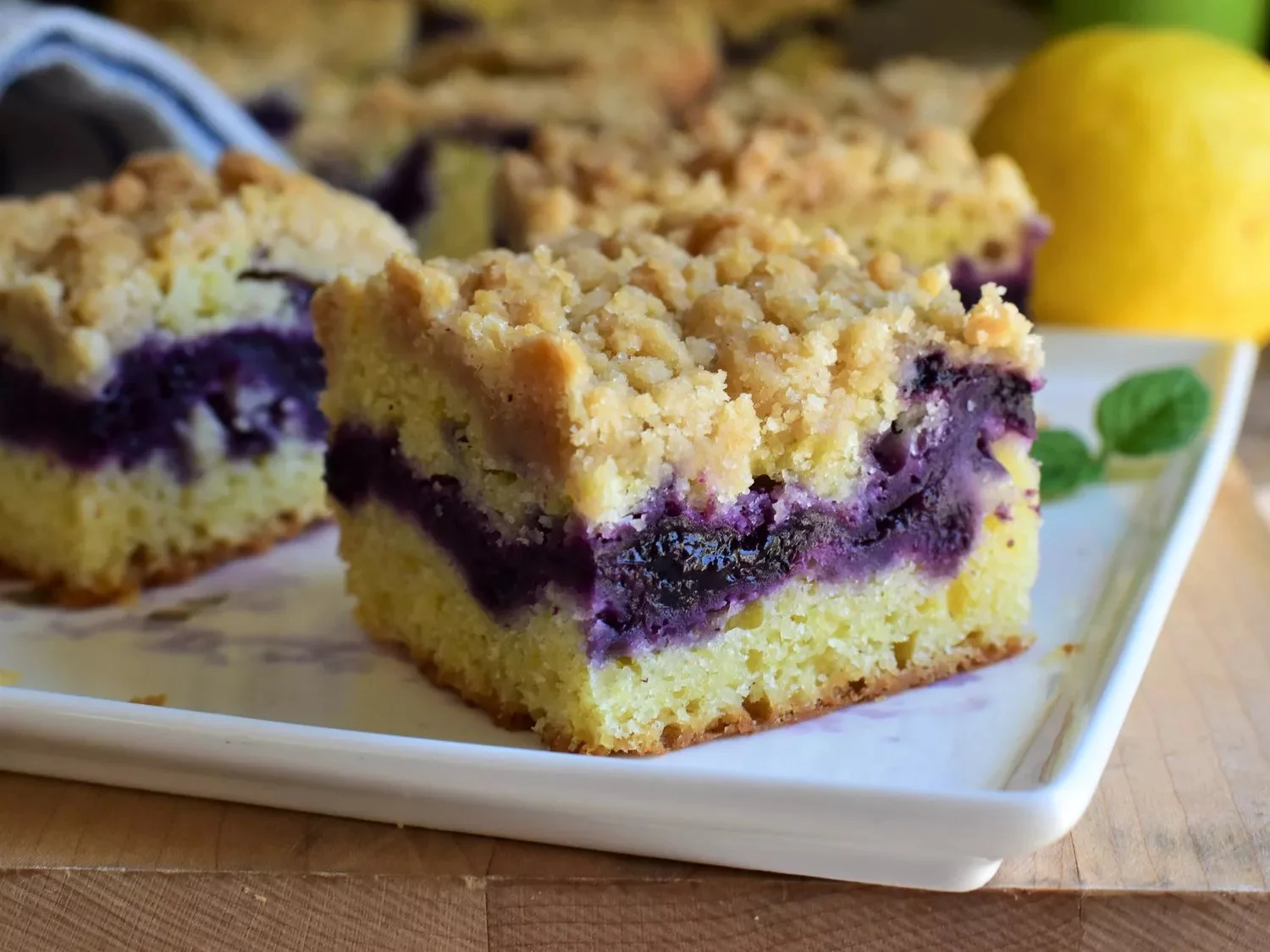 Lemon Blueberry Coffee Cake with vibrant blueberries and yellow lemon glaze.