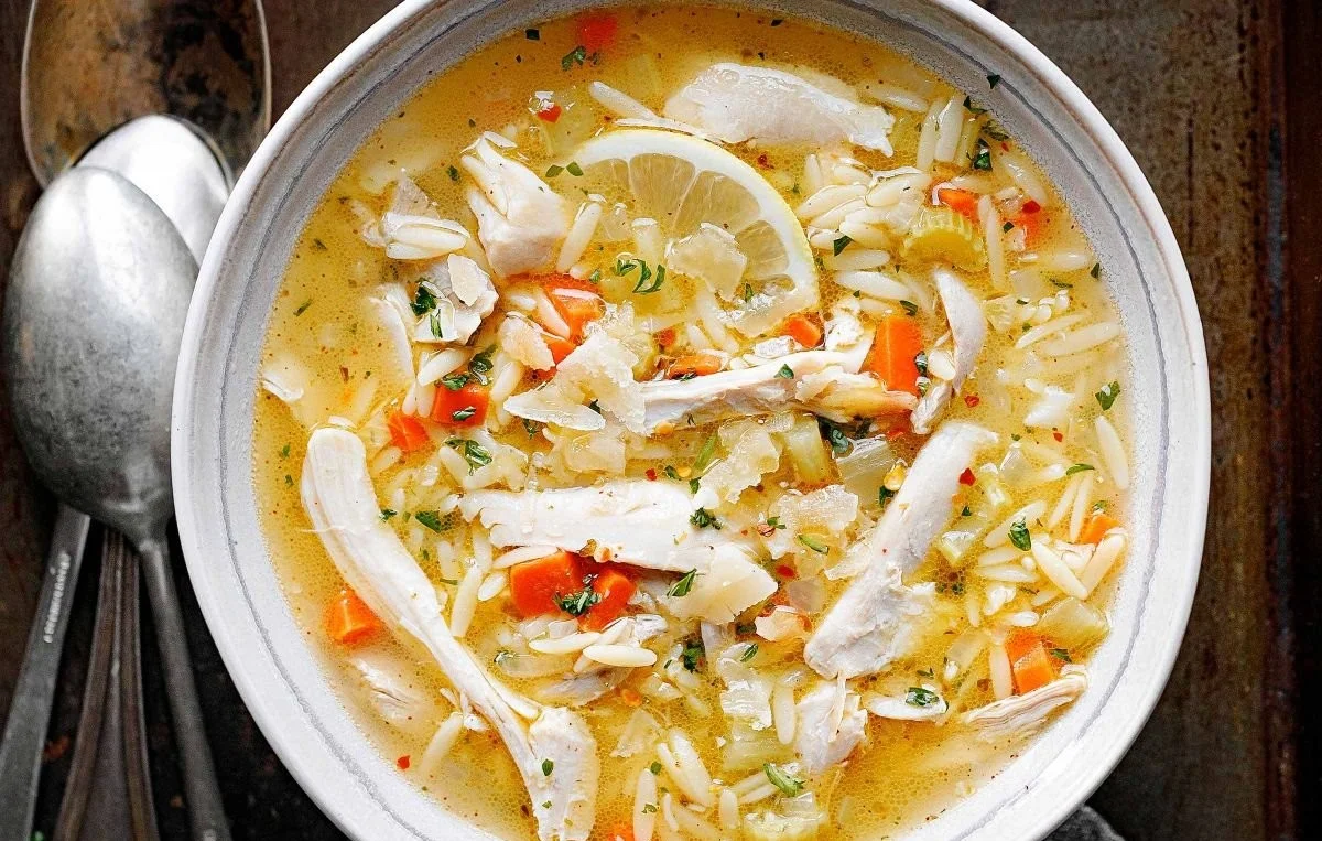 Bowl of delicious Lemon Chicken Orzo Soup with fresh herbs