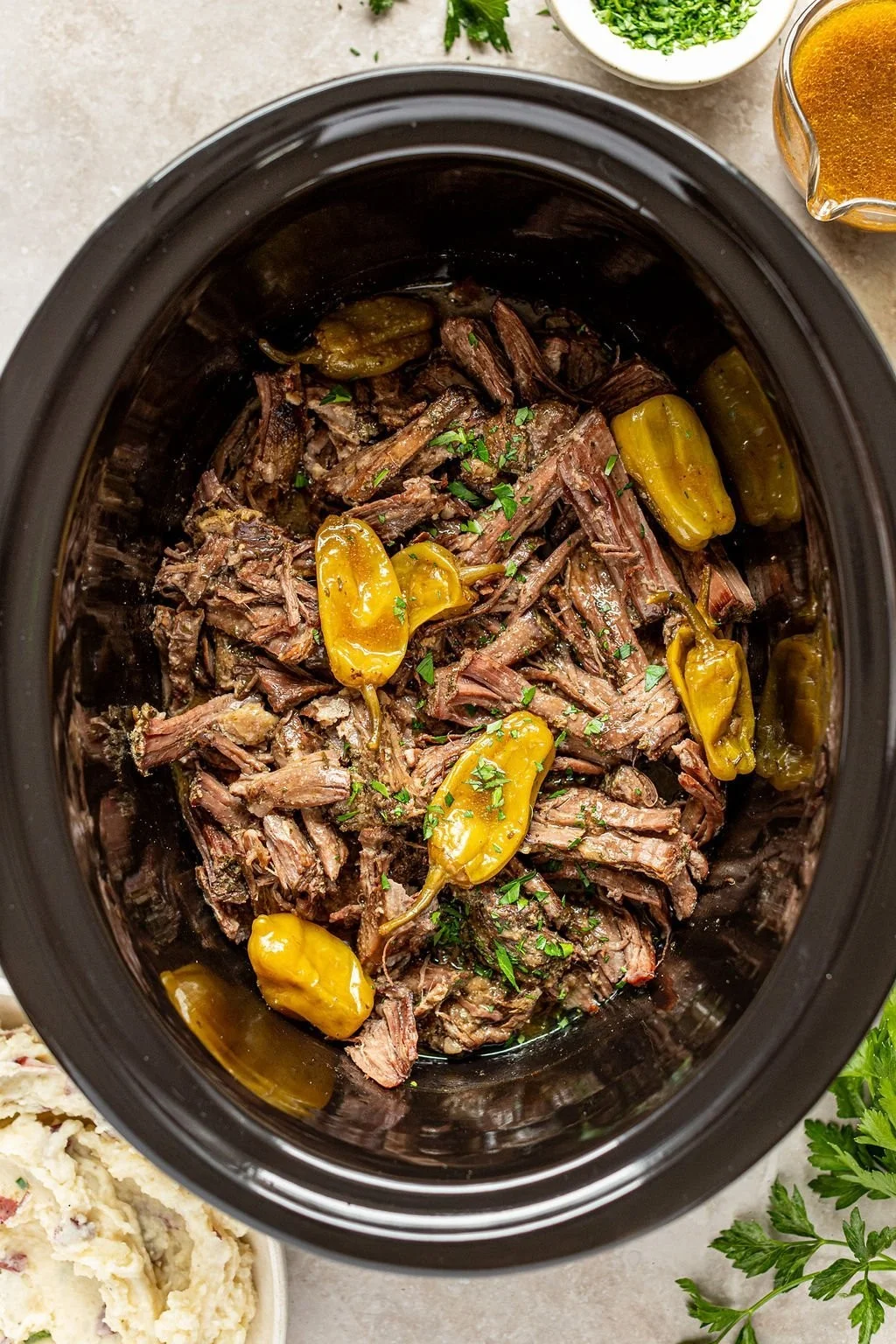 Delicious Mississippi Pot Roast served with vegetables on a rustic table