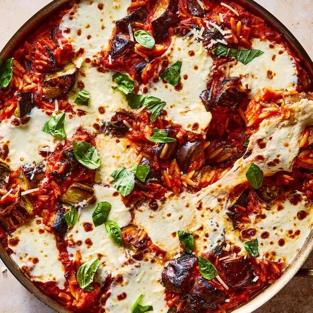 One Pan Eggplant Parm Orzo dish garnished with fresh herbs