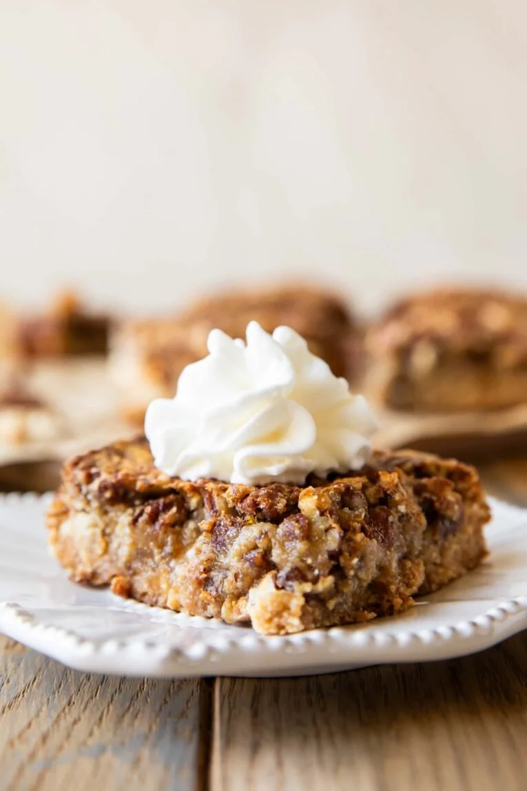 Delicious homemade pecan pie bars topped with pecans and caramel