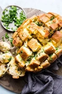 Freshly baked pull apart cheese bread with gooey cheese and golden crust