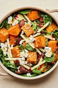 Delicious roasted sweet potato salad with greens and dressing