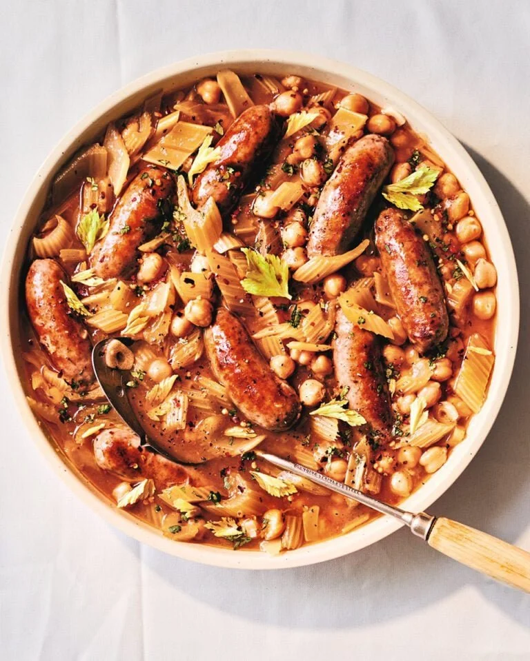 Hearty sausage casserole with braised celery and chickpeas in a rustic bowl