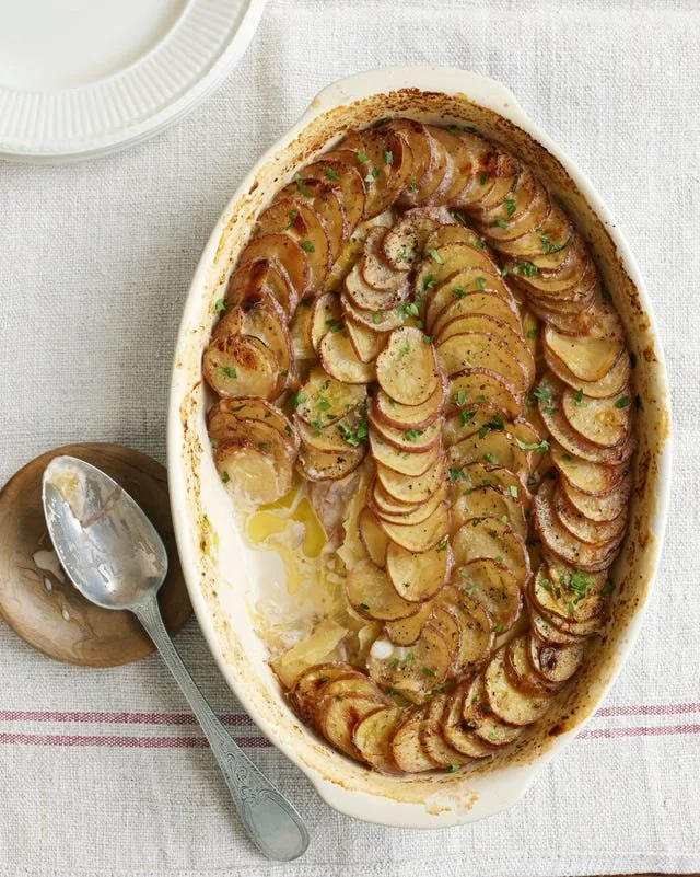 Delicious scalloped leek and potato casserole topped with cheese and herbs.