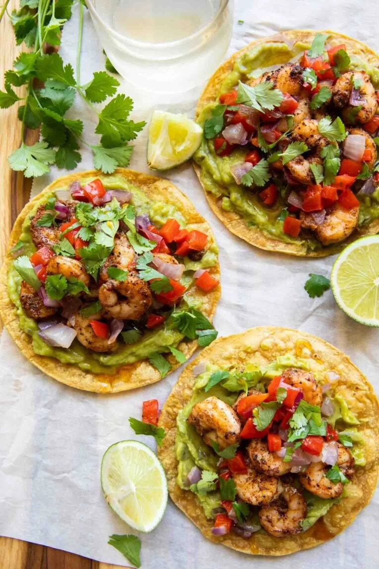 Shrimp guacamole tostadas topped with fresh ingredients and served on crispy tortillas.
