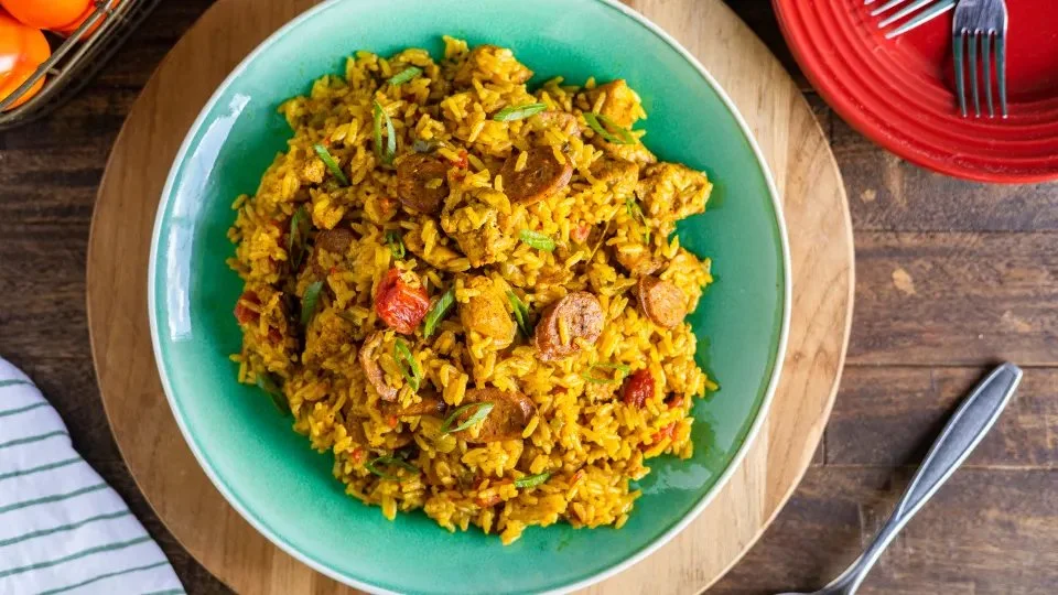 Delicious Chicken and Sausage Paella served in a colorful pan